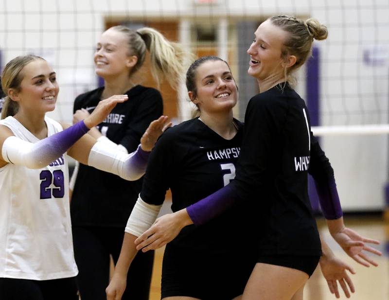 Hampshire's Peyton Wurtz, Jorah Rutter, Kylie Lambert and Elizabeth King celebrate wining the first game of a Fox Valley Conference volleyball match against Crystal Lake Central on Tuesday, Sept. 24, 2024, at Hampshire High School.