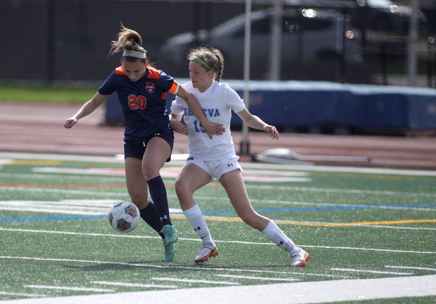 Oswego’s Anna Johnson (20) and Geneva’s Isabella Walls (15) go after the ball during a Naperville Invitational game at Naperville Central on Saturday, April 23, 2022.