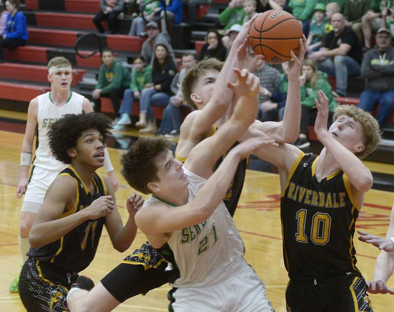 Lane Provance fights for a rebound with Riverdale’s Jake Willems and Brody Clark during the 1st period Friday at Regional Championship at Hall.