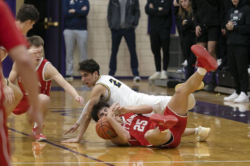 Ottawa’s Payton Knoll and Sterling’s JP Schilling fight for a loose ball the regional final Friday, Feb. 24, 2023.