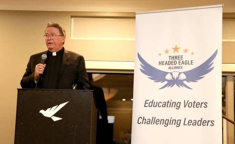 Rev. Stephen C. Lee talks with members and guests of the Three Headed Eagle Alliance during the group’s monthly Pints and Politics program at Eagle Brook Country Club in Geneva on Tuesday, Nov. 14, 2023. Lee was named in the Georgia indictment along with former President Trump over their efforts to overturn his 2020 election loss in the state.