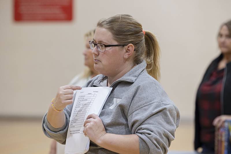 Heather Grobe, daycare director at the Dixon YMCA, gives instruction on how to pack boxes for a food distribution program spearheaded by the YMCA.