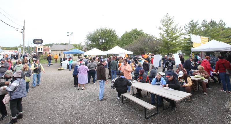 People eat Burgoo stew during the 53rd annual Burgoo on Sunday, Oct. 8, 2023 downtown Utica.