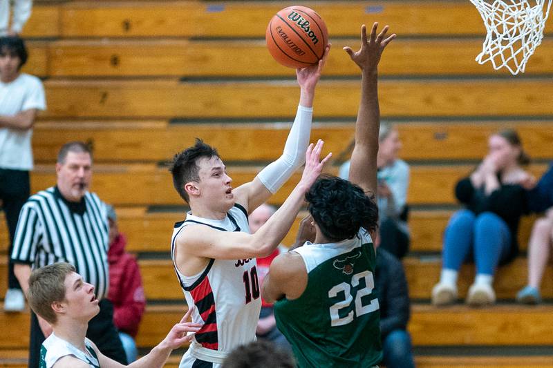 Benet’s Andy Nash (10) shoots a floater over Bartlett’s Ravi Banal (22) during the 4A Addison Trail Regional final at Addison Trail High School in Addison on Friday, Feb 24, 2023.