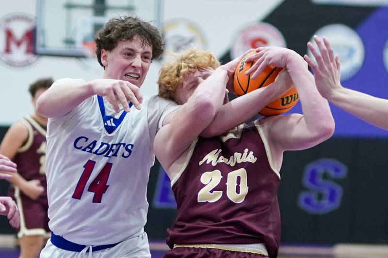 Marmion’s Brendan Kavanaugh (14) and Morris’ RJ Kennedy (20) fight to rebound the ball during a basketball game in the opening round of the 61st annual Plano Christmas Classic at Plano High School on Monday, December 23, 2024.