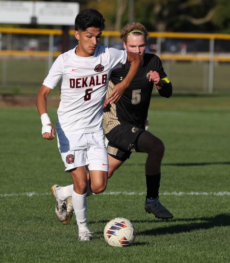DeKalb's Mauricio Jasso pushes the ball ahead of Sycamore's Aiden Sears during the El Classicorn rivalry game Tuesday, Oct. 7, 2025, at Sycamore High School.