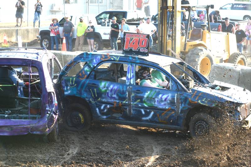Rock Falls siblings, Jacqueline and Justin Shaner, slam into a competitor's car in their demolition derby heat at the Ogle County Fair on Saturday, Aug. 5, 2023.