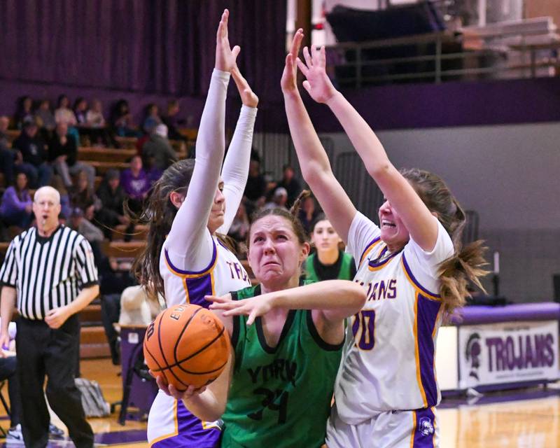York's Olivia Silkaitis, center, takes a shot while being defended by Downers Grove North defenders Campbell Thulin, left, and Lauren Olson, right, during the game on Tuesday Dec. 3, 2024, held at Downers Grove North.