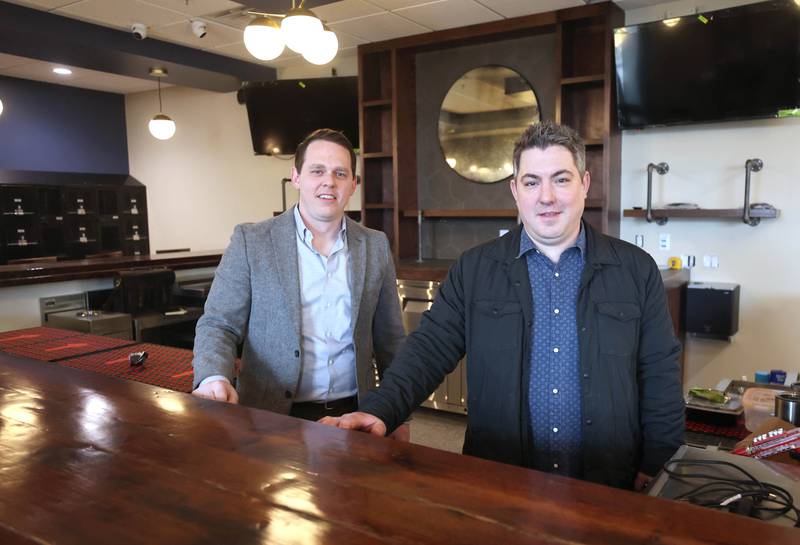 The Grove restaurant and bar owners Sam Patterson (left) and Jason Engstrom, behind the bar Thursday, March 23, 2023, at the new eatery in DeKalb. They plan to open their doors upon completion within the next few weeks.