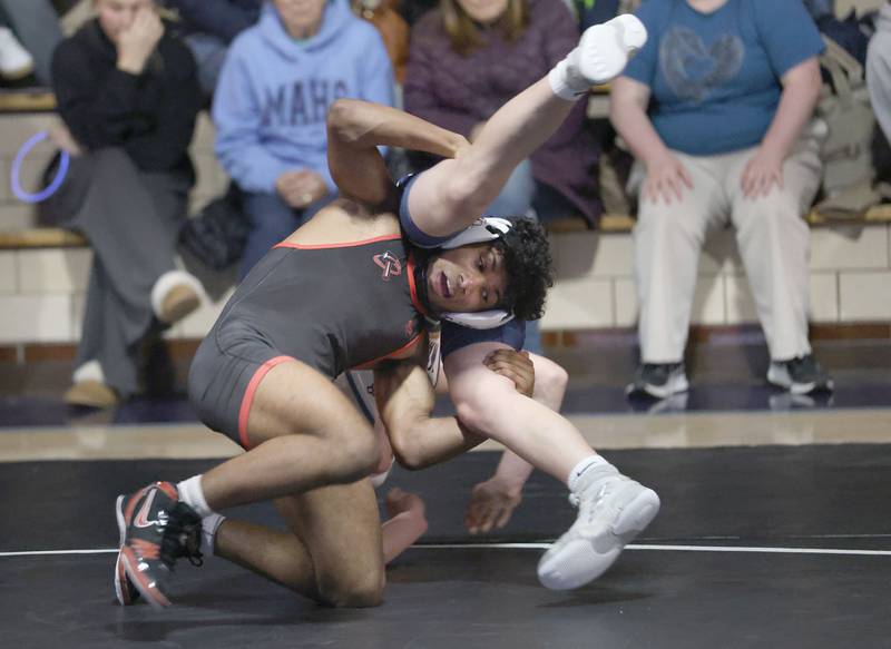 Bradley-Bourbonnias's Razi Perez wrestles Marqutte's Logan Huenfield on Wednesday, Jan. 14, 2026 in Bader Gymnasium at Marquette Academy.