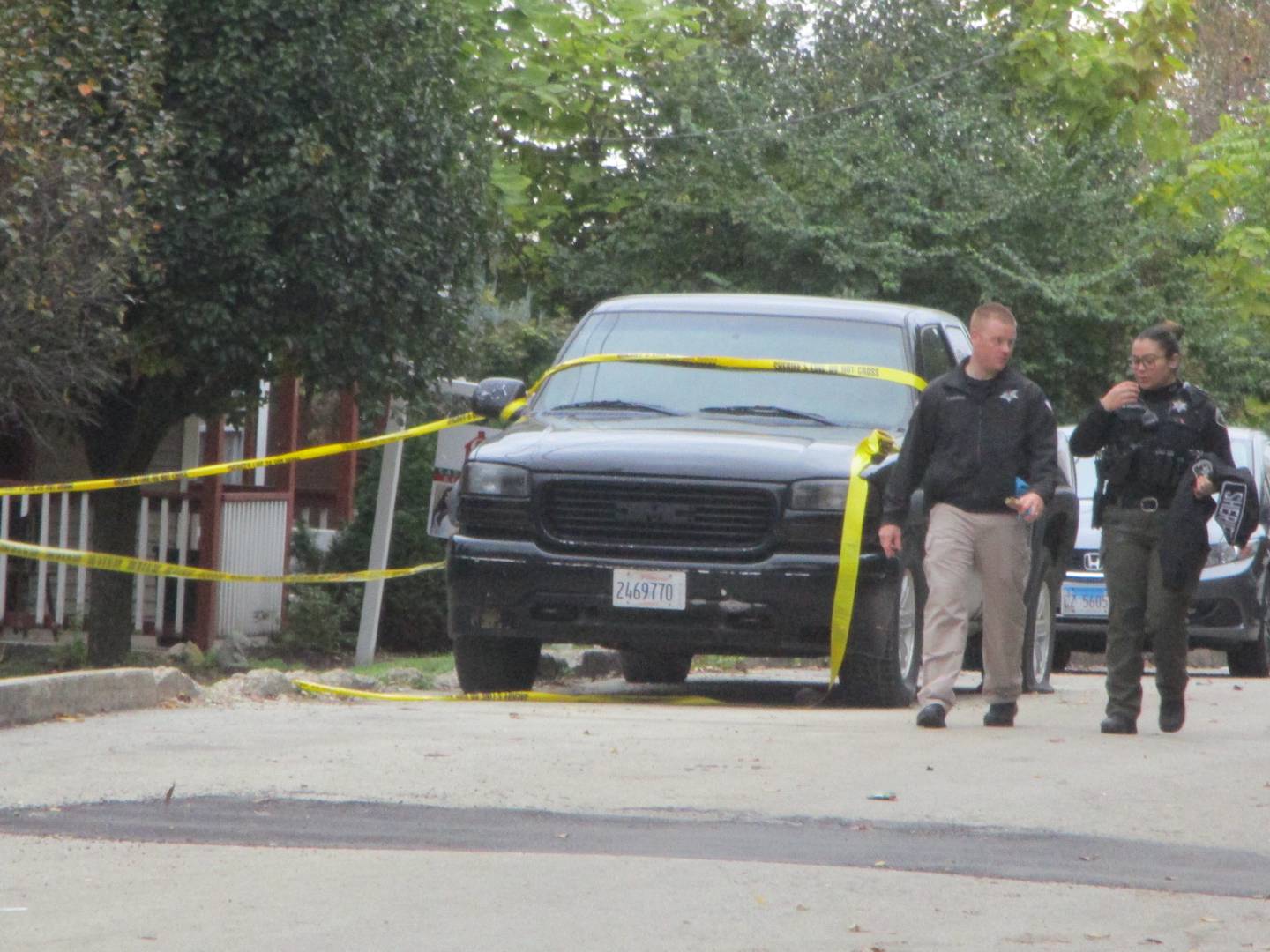 Two police investigators walk away from the house at 1018 E. Jackson St. in Joliet Township where two people were killed and 10 injured by shooters at a Halloween party at about 12:39 a.m. on Sunday, Oct. 31, 2021.