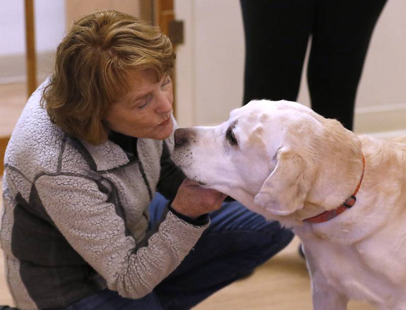 Local filmmaker Gail Gilbert with Scout as she visits with the staff of Helping Paws Animal Shelter on Wednesday, Jan. 15, 2025, to talk about her film "Puppy Love" that will be showing in Classic Cinema theaters in Fox Lake, Woodstock and Carpentersville. Scout is one of the dogs in the film.