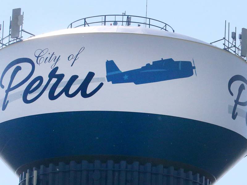A TBM Avenger aircraft flys over the Peru water tower during the TBM Reunion and Air Show on Friday, May 17, 2024 in Peru.