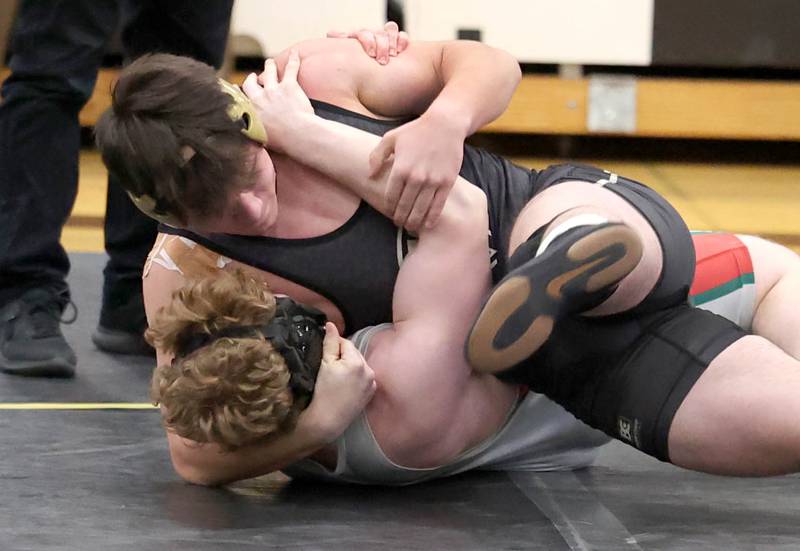 Sycamore’s Hunter Britz and LaSalle Peru’s Jace Wallgren meet in the 182 pound match Thursday, Dec. 1, 2022, during the meet at Sycamore High School.