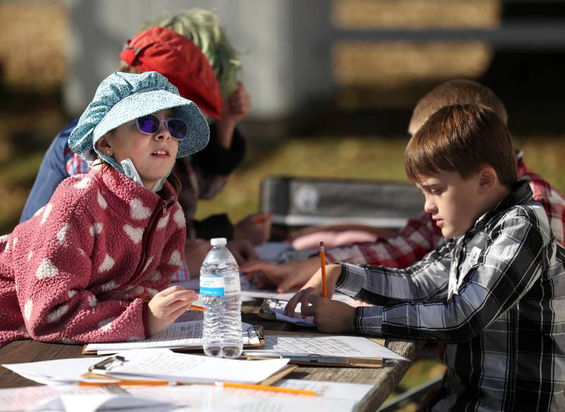 Southeast Elementary School third graders work on a project Tuesday, Nov. 4, 2025, during a field trip to North Grove School, a one-room schoolhouse from 1878 in Sycamore.