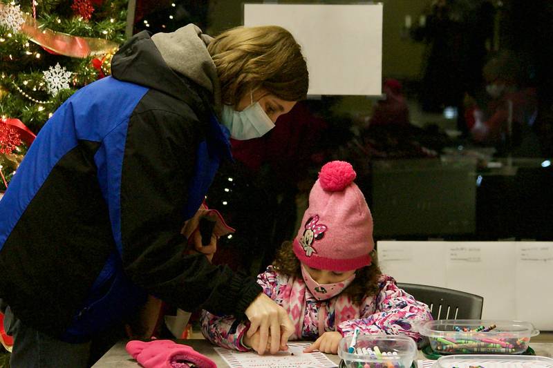 Donna Jungermann helped daughter Morgan write a letter to Santa Claus, during the village of Montgomery's annual Christmas tree lighting celebration Dec. 5 at Village Hall.