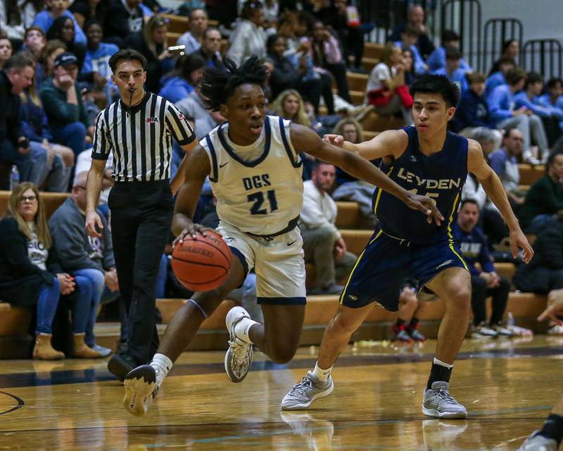 Downers Grove South's Jeremiah Harlin (21) makes a move during basketball game between Leyden at Downers Grove South. Feb 9, 2024.