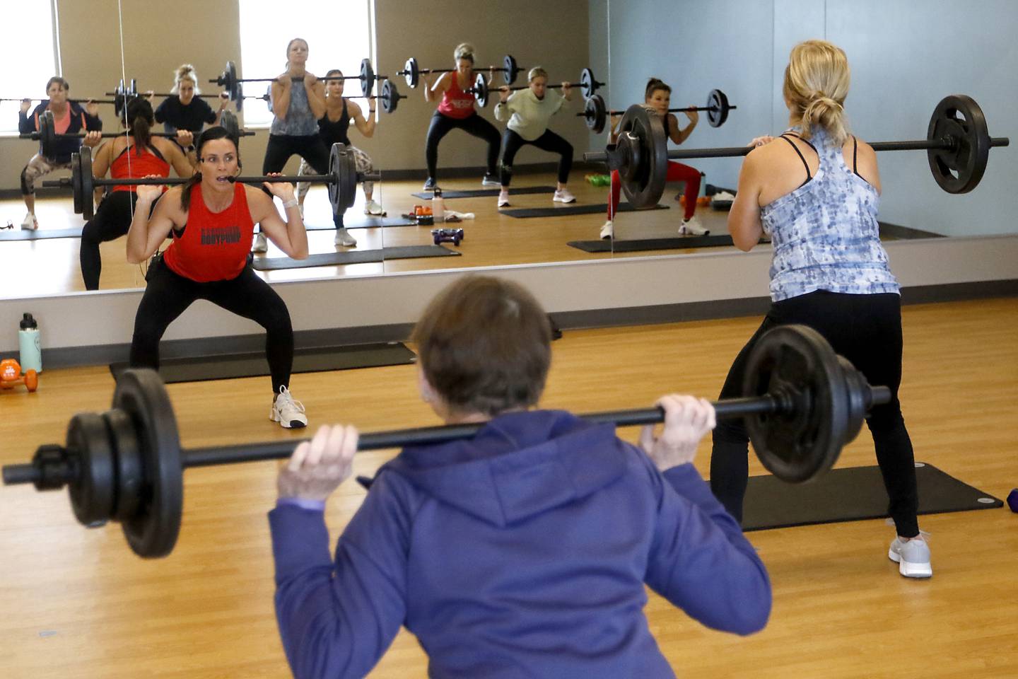 Becky Moore, a fitness coordinator at the McHenry Recreation Center, leads a Les Mills Body Pump and Core class Thursday, Dec. 22, 2022, at the center in McHenry.