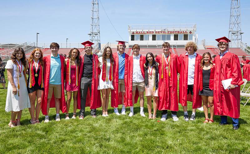 Hall graduates Lili Heredia, Jennifer Casford, Ethan McInnes, Jayden Jones, Hunter Meagher, Clara Jablonski, Riley Coble, Ashton Pecher,  Abby Kaszynski, Grant Plym, Mac Resetich, Ella Taliani, Josh Scheri pose for a photo after the graduation ceremony on Sunday May 21, 2023 at Hall Township High School.