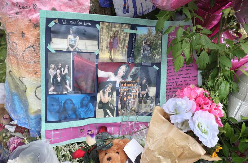 Flowers, balloons, pictures and message adorn a growing memorial for slain teen Gracie Sasso-Cleveland Friday, May 12, 2023, behind a building in the 500 block of College Avenue in DeKalb.