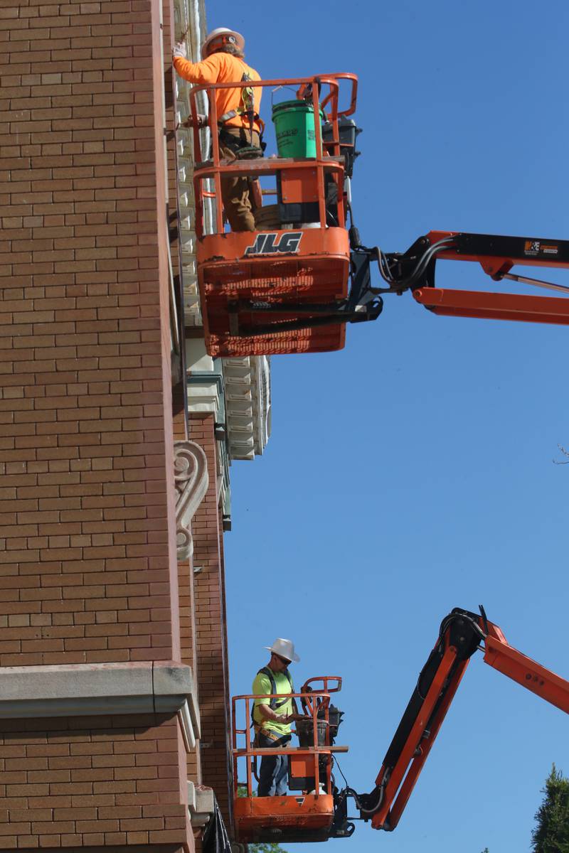 Crews work on tuck-pointing bricks on the exterior of the La Salle City Hall on Tuesday, April 30, 2024.