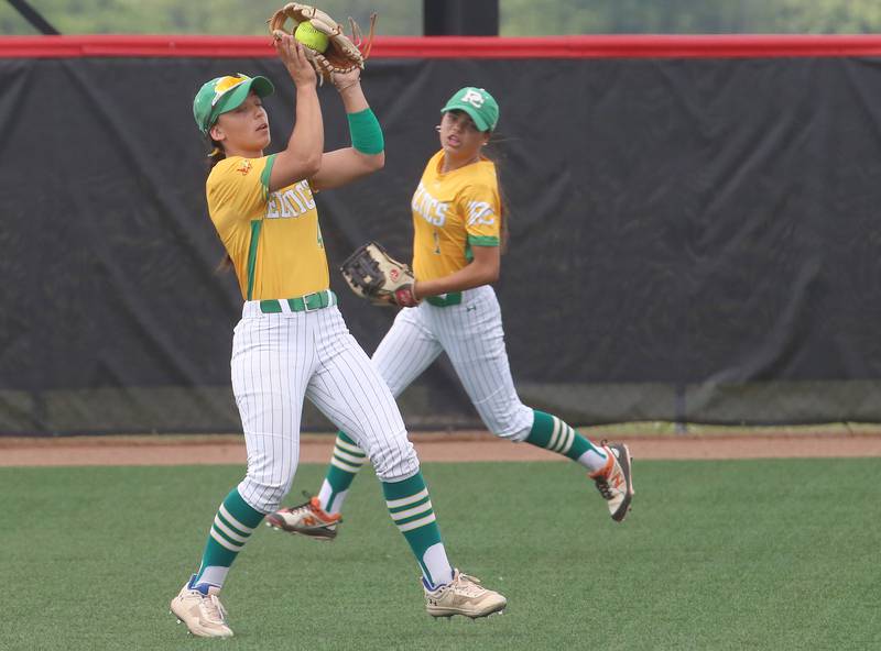 Providence Catholic's Angelina Cole makes a catch in the outfield as teammate Bells Cortez backs up the play during the Class 3A State finals game on Saturday, June 14, 2025 at the Louisville Slugger Sports Complex in Peoria.