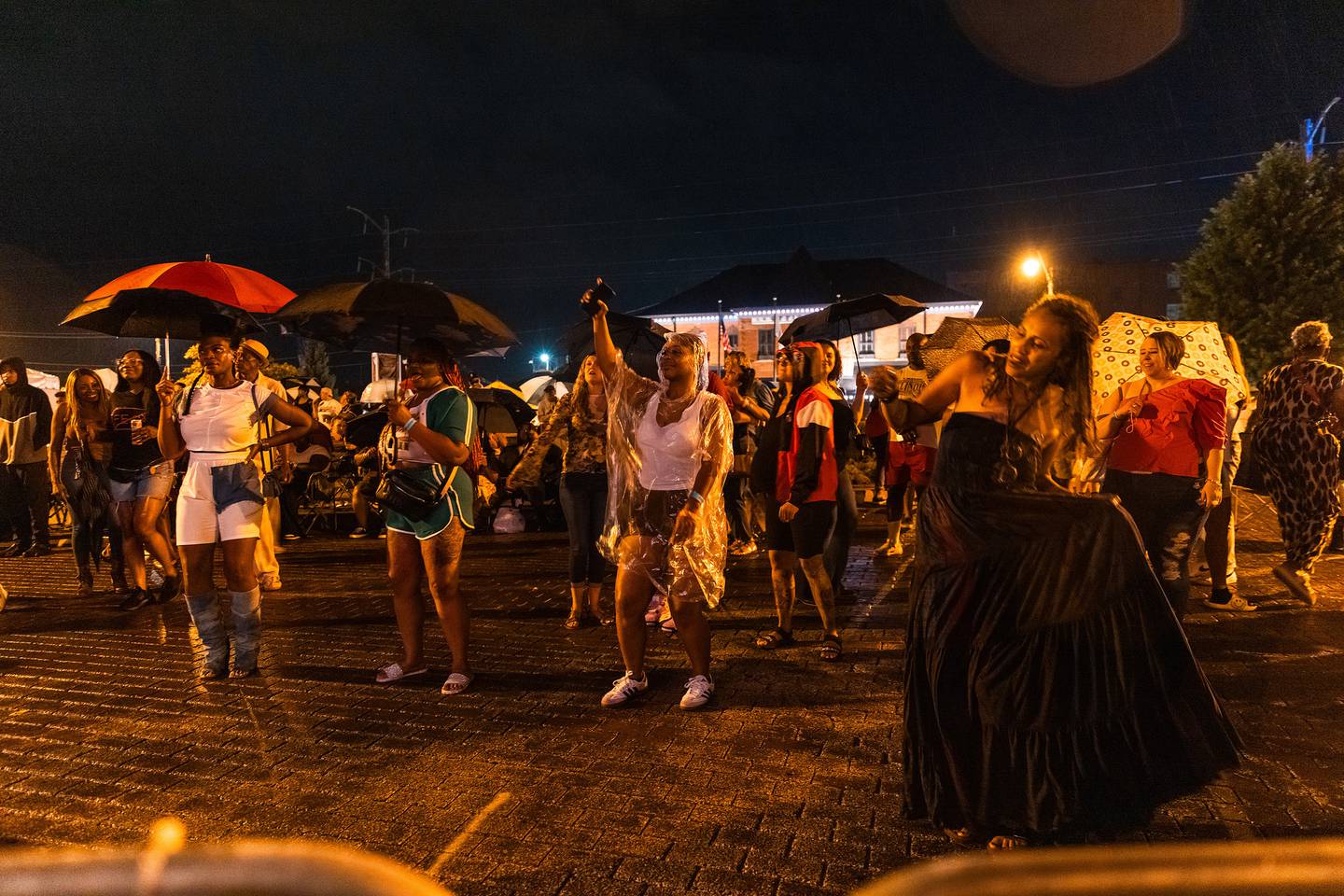 Attendees dance under umbrellas during Merchant Street MusicFest on Saturday, July 26, 2025.