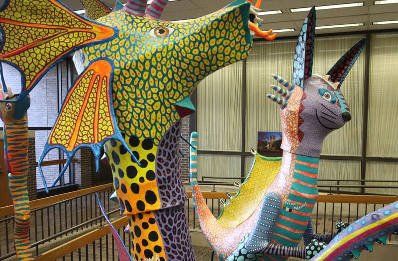 Two of the alebrijes, Lacuarium, (left) by Alejandro Camacho Barrera and Tochtli, by Perla Miriam Salgado Zamorano, Thursday, Feb. 29, 2024, in Founders Memorial Library at Northern Illinois University in DeKalb.