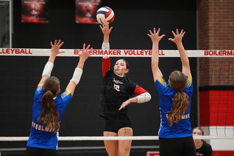Bradley-Bourbonnais' Ella Haas tips the ball over Joliet Central players during their match at the Moldenhauer Classic tournament on Saturday, Oct. 18, 2025, at Bradley-Bourbonnais Community High School.