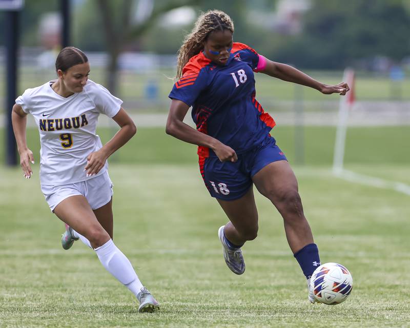 Oswego's Jordyn Washington (18) chases down the ball with Neuqua Valley's Sarah Shannon (9) in pursuit during Class 3A regional final soccer match between Neuqua Valley at Oswego on Saturday, May 23, 2026 in Oswego.