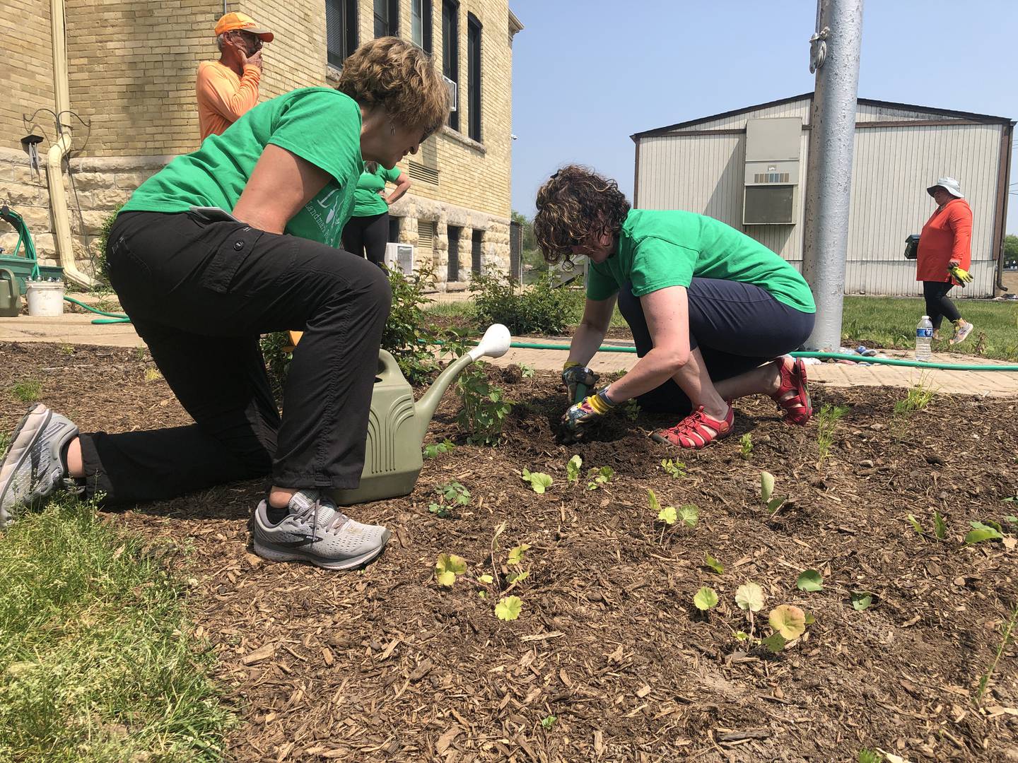 Principal Margaret Carey, left, and teacher Jessica Hodge, helped to water the newly-planted pollinator garden at Landmark School, 3614 Waukegan Road, McHenry, on May 23, 2023.