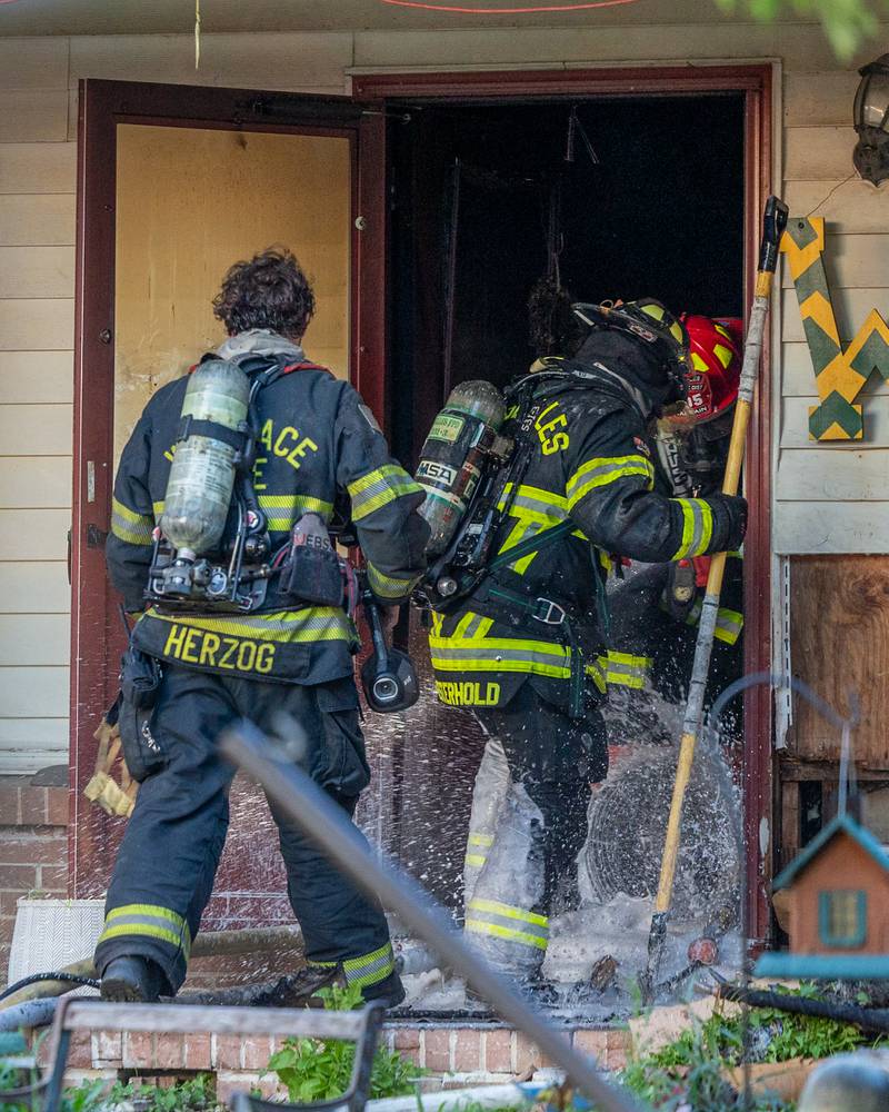 Firefighters enter a structure fire on Saturday, July 19, 2025, in the 1400 Block of U.S. Route 6 in Ottawa.