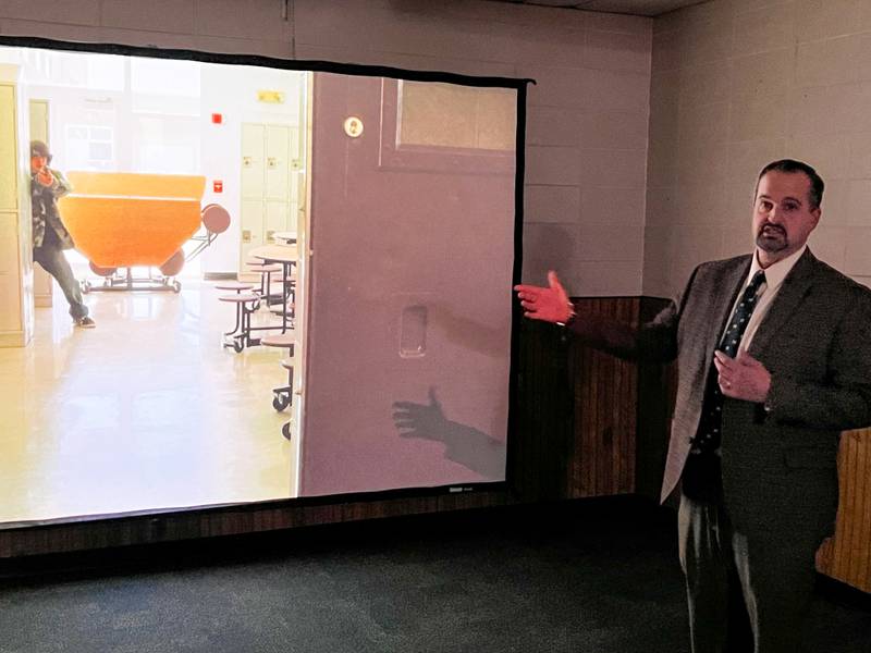 Jon Mandrell,  vice president of academics and student services at Sauk Valley Community College, showcases an active-shooter training module. The demonstration is taking place in the Situation Room, an interactive simulation-based training program for law enforcement officers and students.