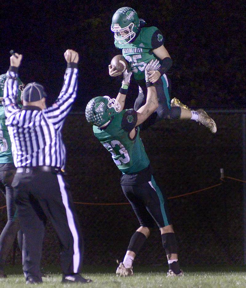 Seneca’s Kysen Klinker lifts Nathan Neal in the air after Neal scored a touchdown against Dwight in the 1st quarter Friday at Seneca.