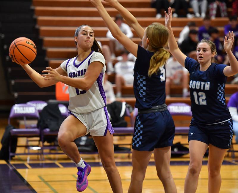 Downers Grove North’s Adysen Fanta passes as Downers Grove South’s Molly Mihalik (5) Erin Sievert (12) defend during a game on December 20, 2025 at Downers Grove North High School in Downers Grove.
