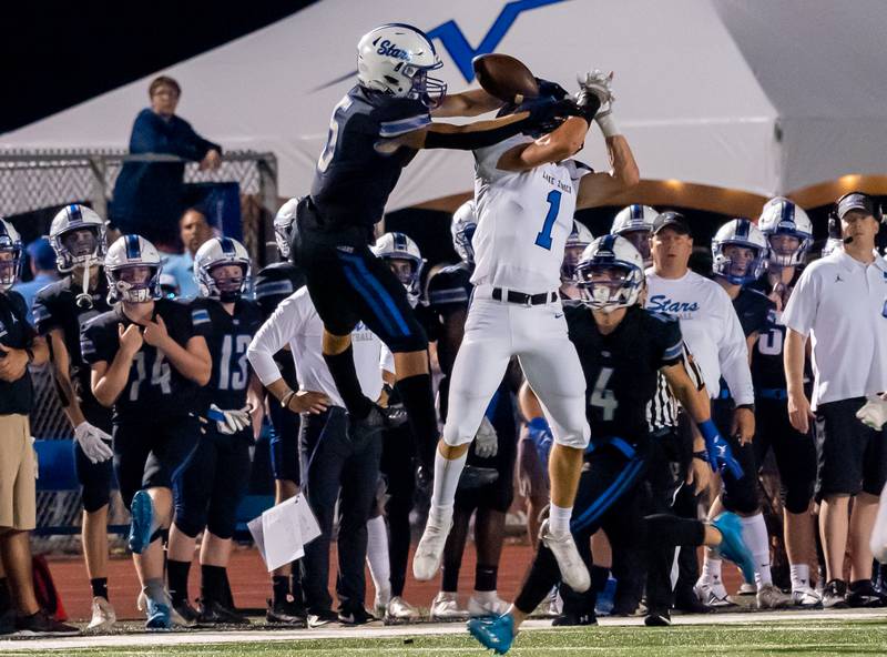 Lake Zurich's John DeGustino (1) breaks up a pass intended for St. Charles North's Anthony Taormina (5) during a football game at St. Charles North High School on Friday, Sep 2, 2022.