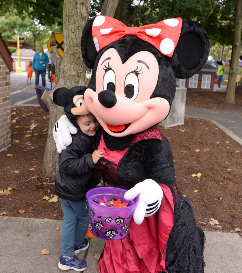 Daniel Kamenov of Wood Dale give Mini Mouse a hug while trick or treating through Safety Town during the Elmhurst Park District Family Fall Fest Saturday, Oct. 5, 2024.