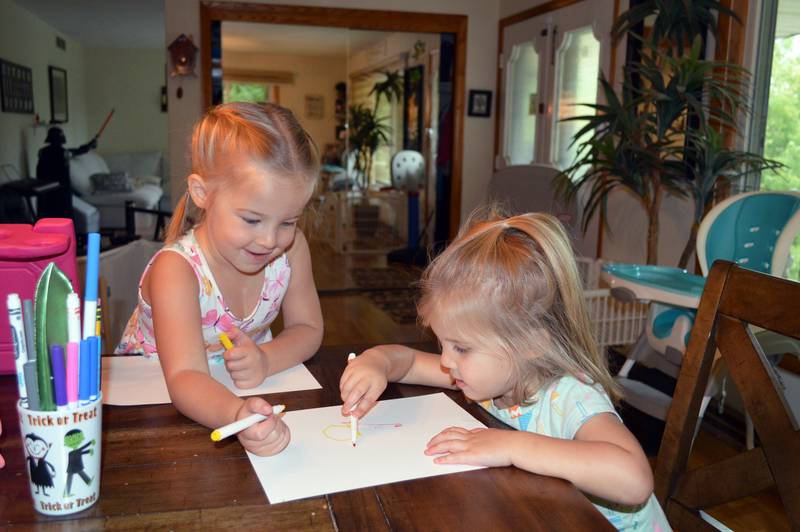 Aislynn Skinner, 4, left, colors with little sister Breelyn Skinner, 2, at their Oregon home on Sept. 6, 2023. Aislynn, who was diagnosed with a critical congenital heart defect in utero, was selected as an American Heart Association Community Youth Heart Ambassador for the 2023-24 school year.