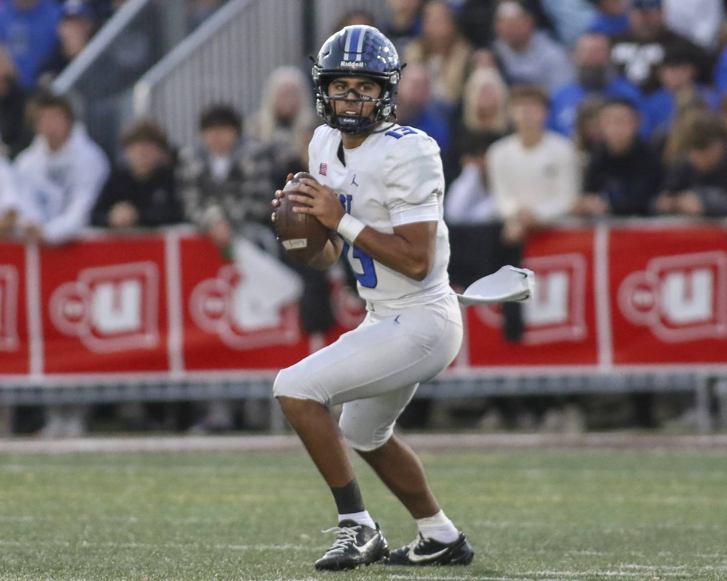 Lincoln-Way East's Jonas Williams (13) drops back to pass during Class 8A quarterfinal football game between Lincoln-Way East at Mount Carmel. Saturday, Nov 15, 2025 in Chicago.
