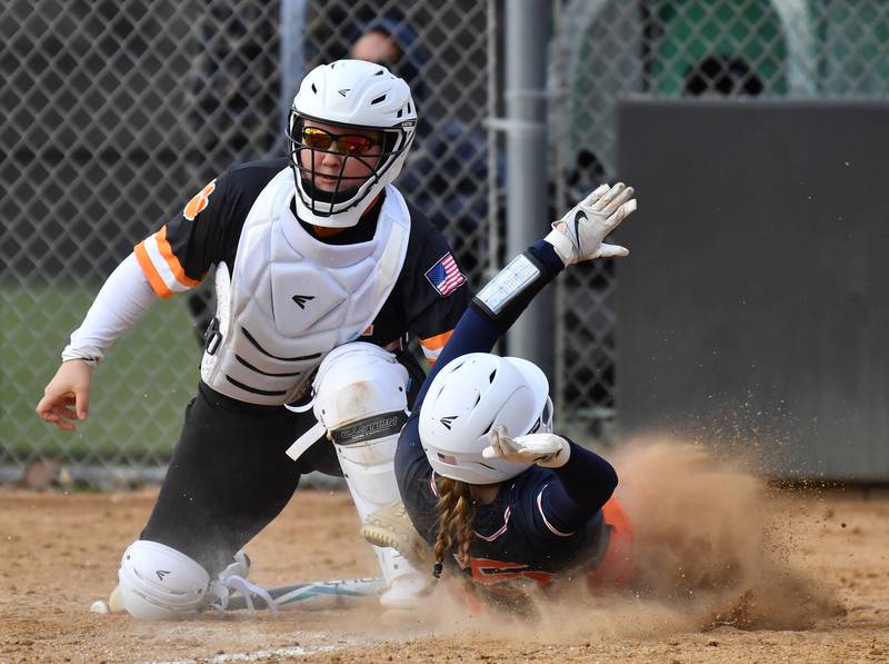 Wheaton Warrenville South catcher Lily Bobor tags out Oswego’s Adalynn Fugitt during a game on April 10, 2025 at Wheaton Warrenville South High School in Wheaton.