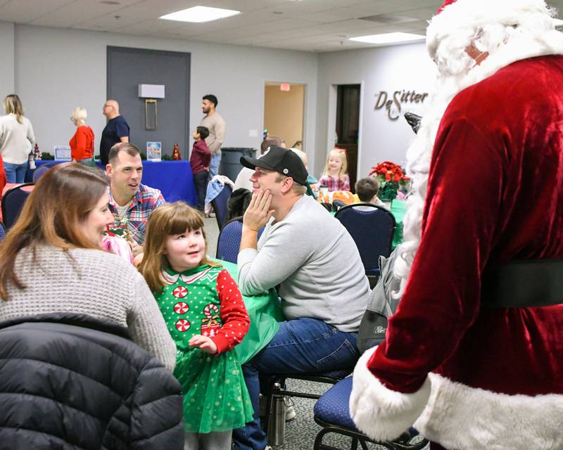 Maddie Lynch, 4, of La Grange says hello to Santa as he makes his rounds around the room before breakfast on Sunday Dec. 15, 2024, during the breakfast with Santa event held at the La Grange Park District Recreation Center.