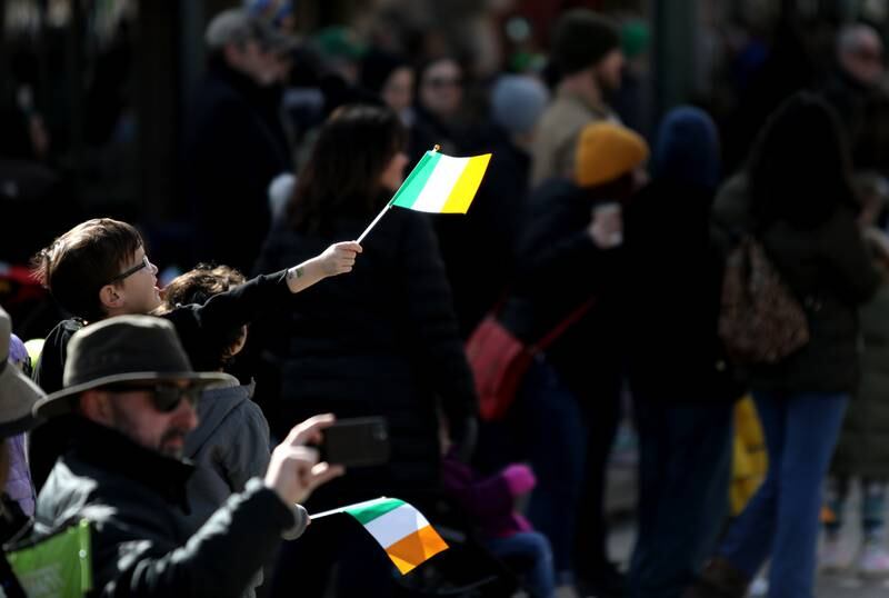 A child waves an Irish flag before the St. Charles St. Patrick Day Parade on Saturday, March 9, 2024.