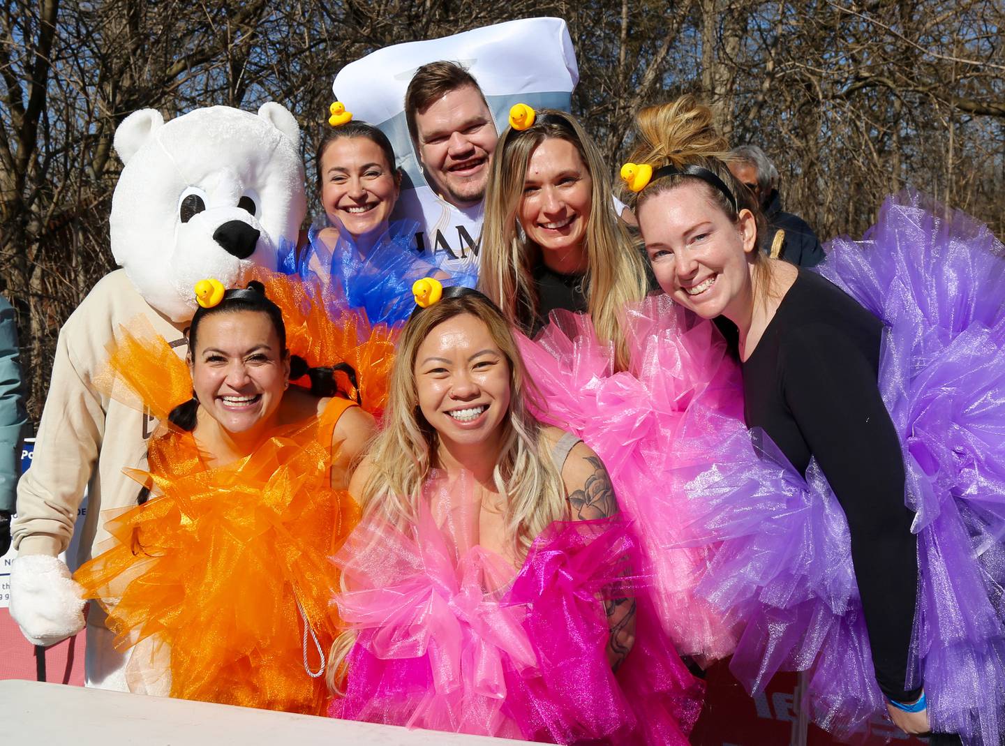 Plungers pose for a photo before plunging in Loon Lake at the Yorkville Polar Plunge on Sunday, March 2, 2025.