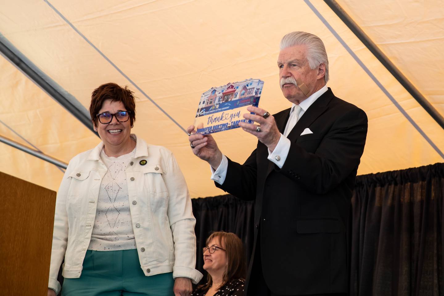 Will County State's Attorney, and Founder of the Will County Children's Advocacy Center, James W. Glasgow, presents Will County Executive, Jennifer Bertino-Tarrant with an award during the ribbon cutting and open house on April 8, 2024.