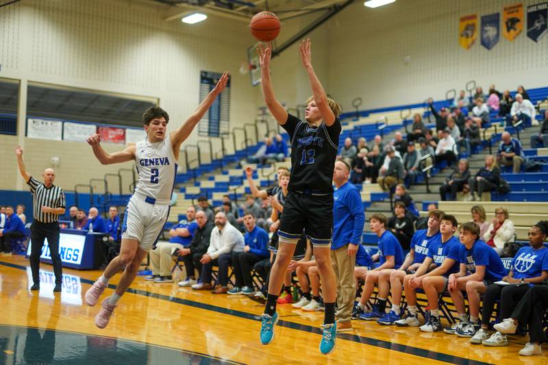 St. Charles North's Parker Reinke (12) shoots a three pointer over Geneva’s Gabe Jensen (2) during a basketball game at Geneva High School on Wednesday, Feb 14, 2024.