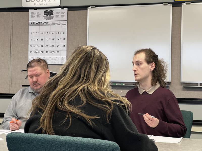Interim DeKalb County administrator Derek Hiland and Cortland engineer and zoning administrator look at DeKalb-Sycamore Area Transportation Study documents on Feb. 5, 2025, while DSATS coordinator Jacob Johnson talks during a transportation advisory committee meeting.