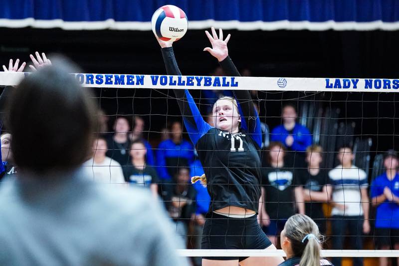 Newark’s Zoey Carlson (17) defends the net blocking a kill attempt during a non-conference match against Aurora Christian at Newark High School on Tuesday, Sept. 9, 2025.