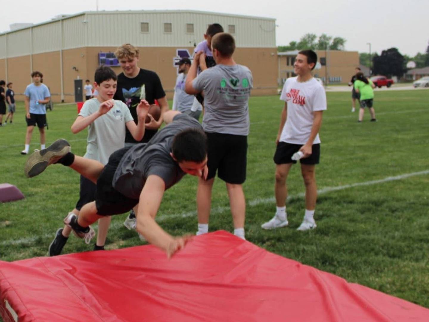 Camper Liam Clyden sends Manteno's Kalub Jankuski flying into the tackling mat during a drill at the Manteno Tackling Disabilities camp on June 12, 2025.