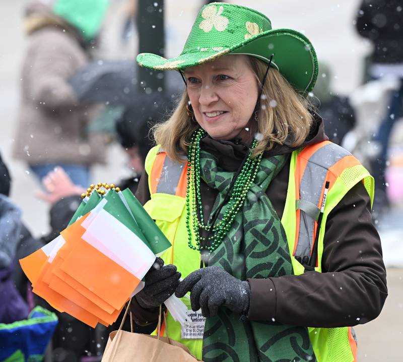 Michelle Fisher of the St. Charles Business Alliance hands out Irish flags at the St. Charles St. Patrick’s Parade Saturday, March 14, 2026.