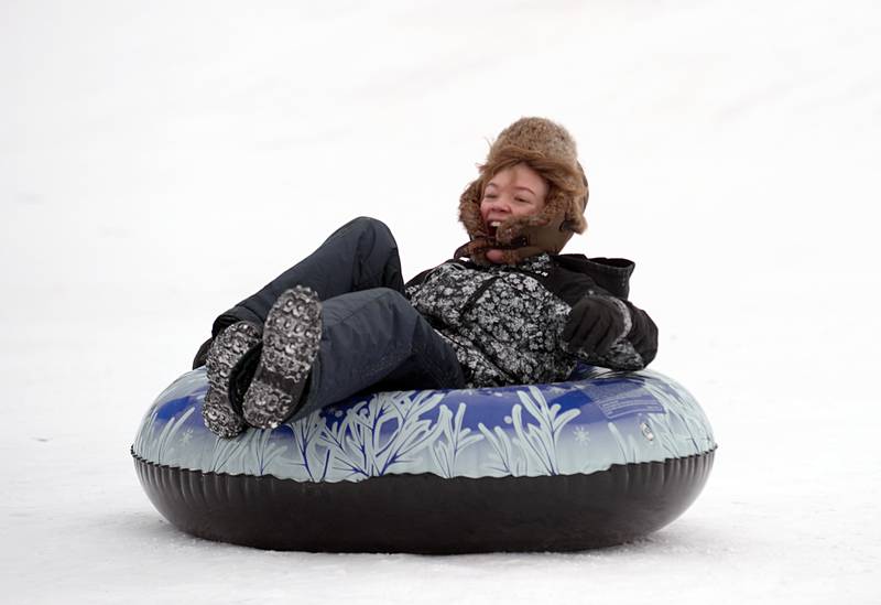 Children including Jackson Beasley enjoy the winter storm sledding at Northside Park in Wheaton Saturday, Jan 13, 2024.